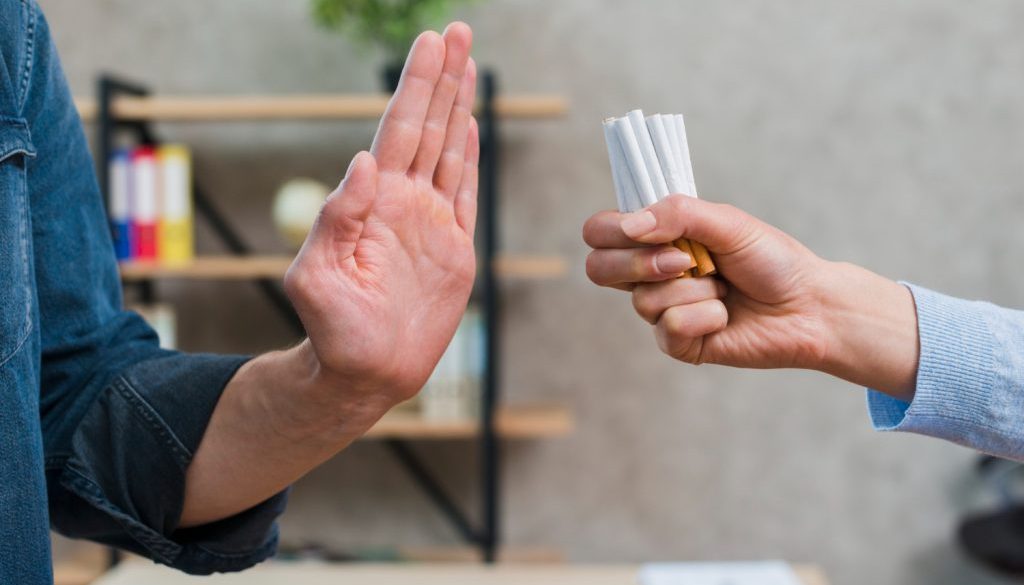 man-refusing-bunch-cigarettes-offered-by-his-female-friend