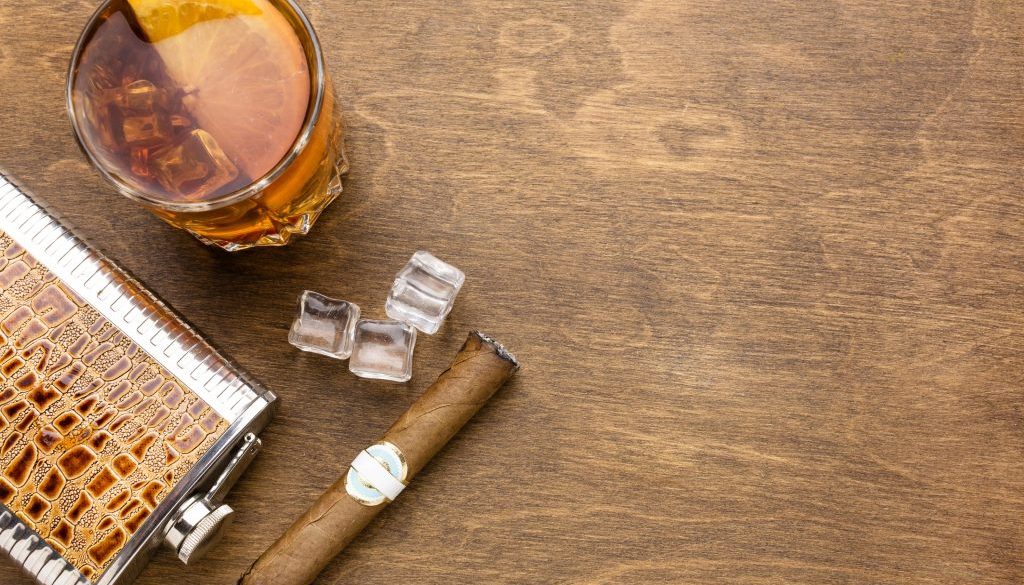 top-view-whiskey-with-orange-cigar-with-copy-space